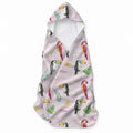 Pale pink hooded towel featuring red and yellow parrots, toucans, tropical leaves, flowers, butterflies, and the name Mae.