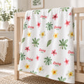 Personalized Tropical Flower Baby Blanket. Watercolor tropical flowers in pink and yellow mingle with green leaves around a custom name.
