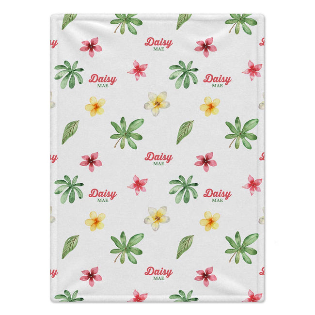 Personalized Tropical Flower Baby Blanket. Watercolor tropical flowers in pink and yellow mingle with green leaves around a custom name.