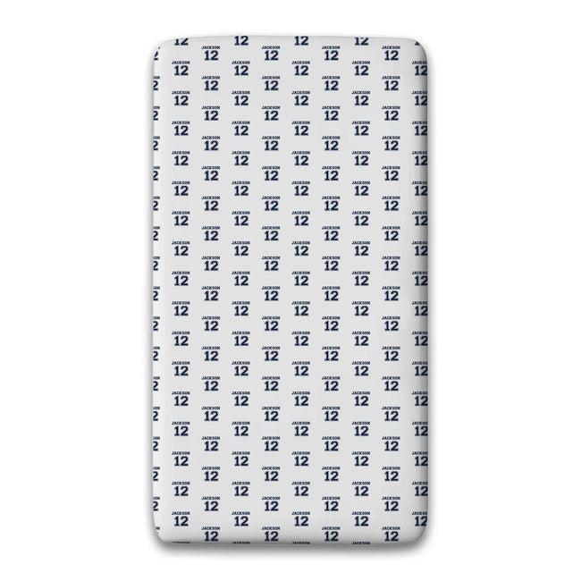 A personalized fitted sheet featuring a varsity name and number repeated pattern.