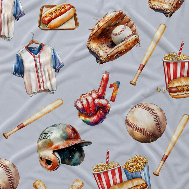 A close-up of a light gray fabric printed with a repeating baseball-themed pattern, including baseballs, bats, a glove, a baseball cap, a jersey, hot dogs, popcorn, and a colorful thumbs-up graphic.