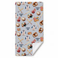 A personalized beach towel with a light gray background and a repeating pattern of baseball-themed illustrations, including baseballs, bats, jerseys, helmets, and the name 'CONNOR 12'. The bottom corner is folded over to show the white reverse side.