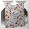 A light gray blanket featuring a baseball-themed pattern with baseballs, bats, jerseys, helmets, and the name 'CONNOR 12', draped over a white wooden bed frame.