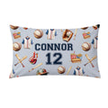 A pillowcase featuring a baseball-themed pattern with the name 'CONNOR' and number '12' in navy blue, surrounded by baseball jerseys, balls, bats, and a glove.