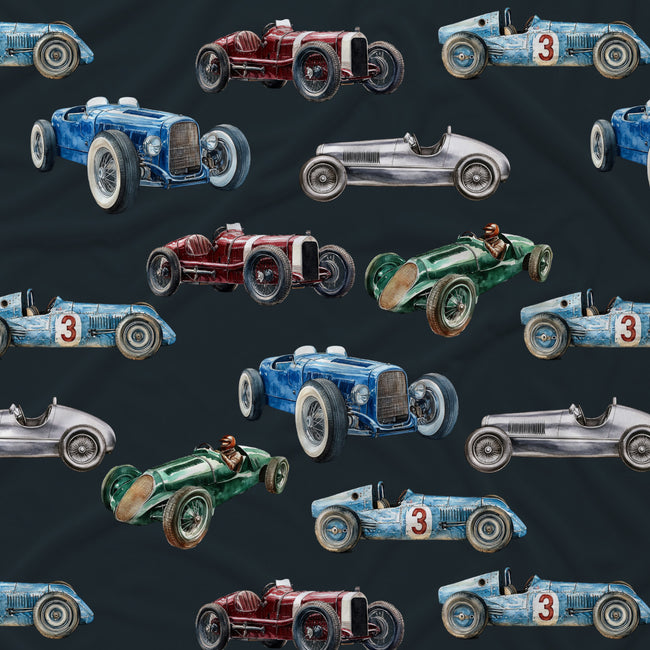 A repeating pattern of vintage racing cars in blue, red, green, and silver on a dark charcoal background. The cars are illustrated in a retro watercolor style, with several featuring the number 3 on the side.