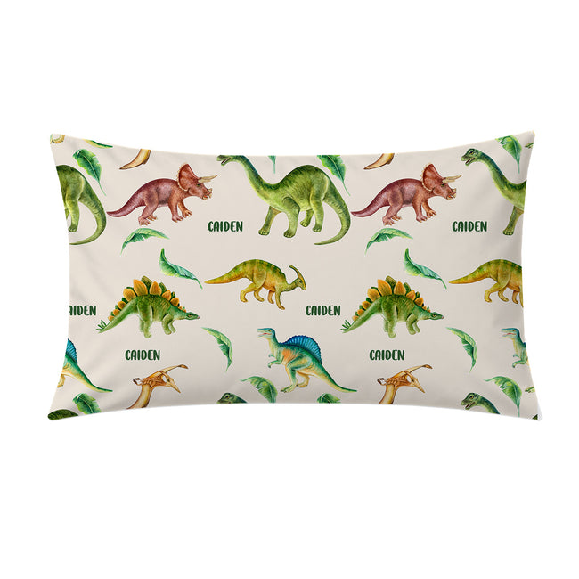 A personalized pillowcase featuring a colorful watercolor dinosaur pattern on a cream background, with the name 'CAIDEN' printed next to some dinosaurs.