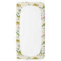 A personalized twin fitted sheet with an elasticized corner border, featuring a colorful dinosaur pattern on an off-white background.