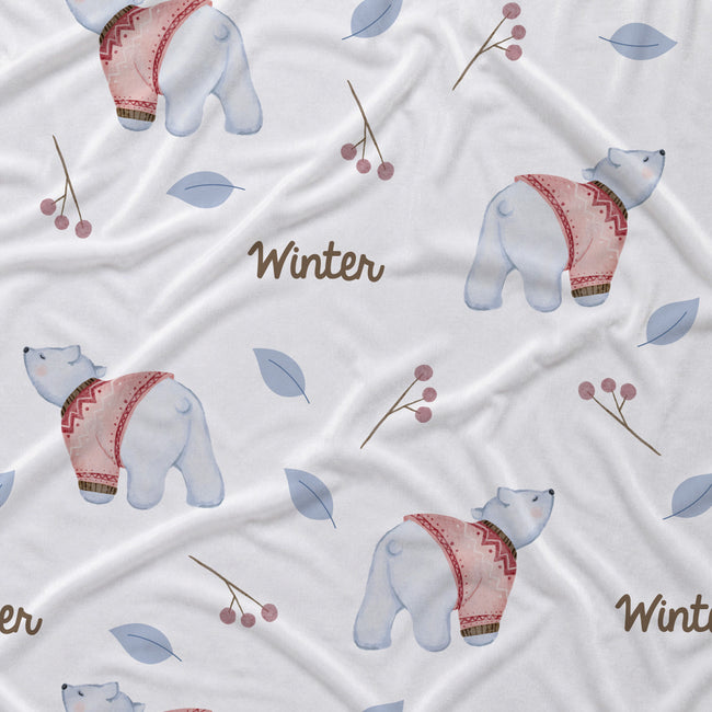 White fabric with a winter-themed print featuring watercolor polar bears wearing pink patterned sweaters, blue-gray leaves, berry branches, and the word 'Winter' in brown script.