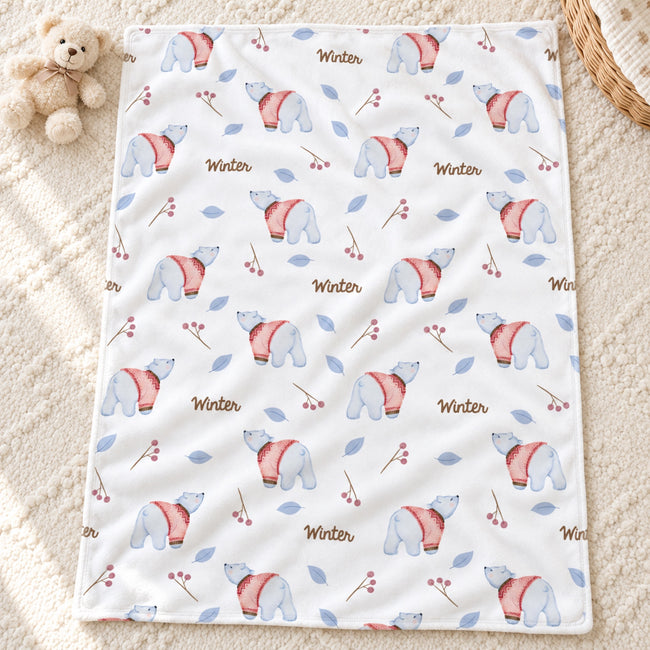 Personalized Polar Bear Baby Blanket. Gentle polar bears in pink sweaters, blue leaves, and berry sprigs surround a custom name on a white background.