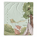 A square baby milestone blanket featuring a watercolor illustration of a fox holding a kite next to a tree and a teepee, with printed numbers 1 through 12 and the word 'months' on a pale mint background.
