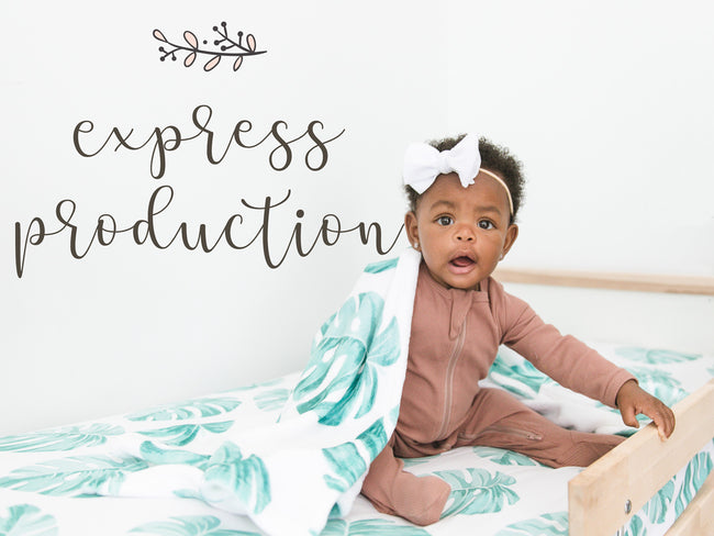 A baby sitting on a bed with a 'express production' text above it, indicating a rush service for fast production and shipping of custom products.