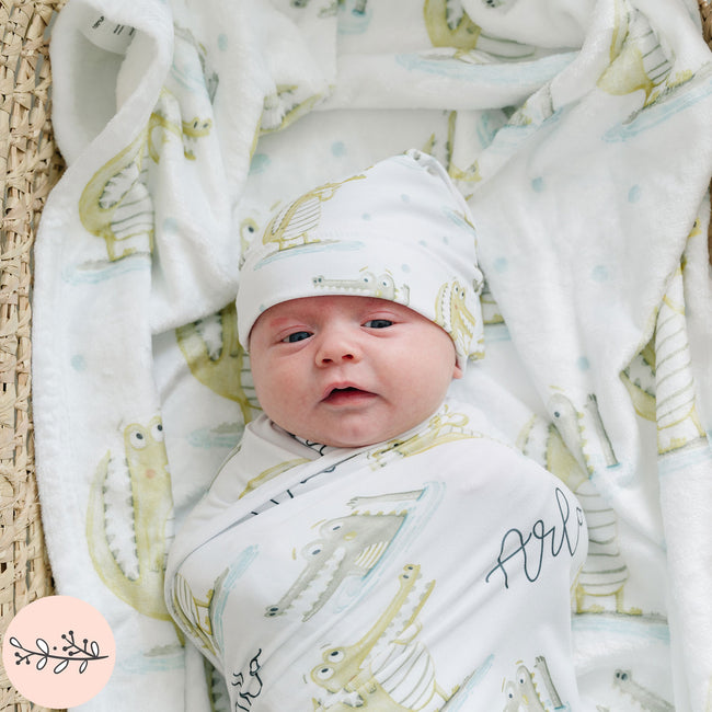 closeup of baby wrapped in a gator personalized baby blanket