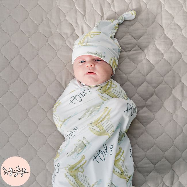baby in a gator personalized baby swaddle set