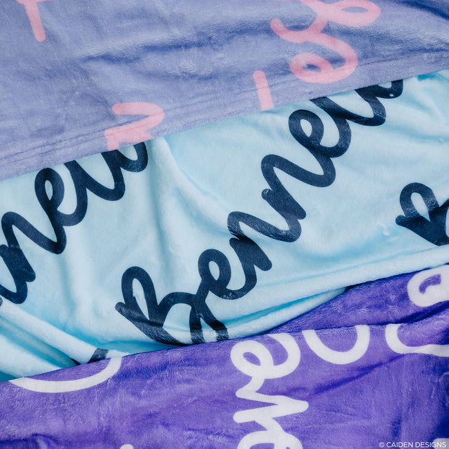 three personalized blankets with script font