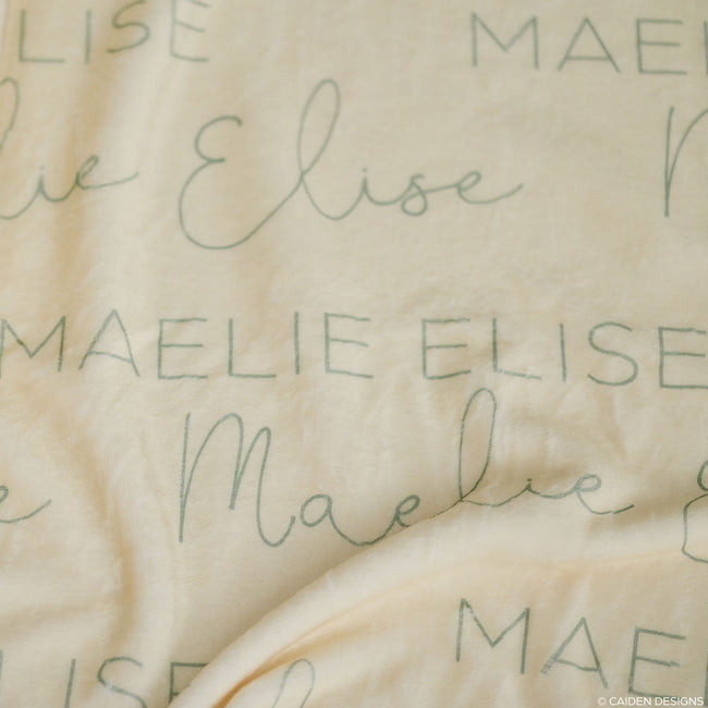 Closeup of a personalized baby blanket with names on it