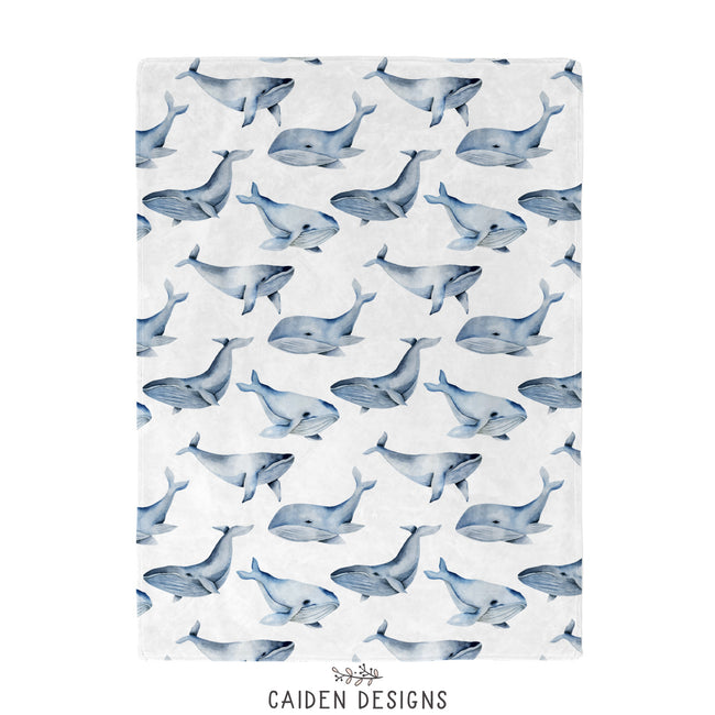 A blue and white whales baby blanket