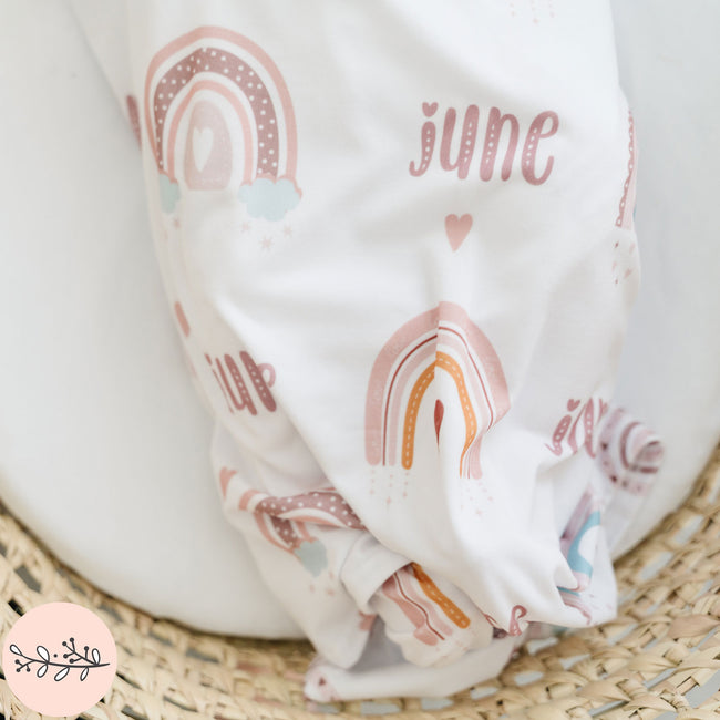 closeup of a personalized boho baby swaddle with the name June