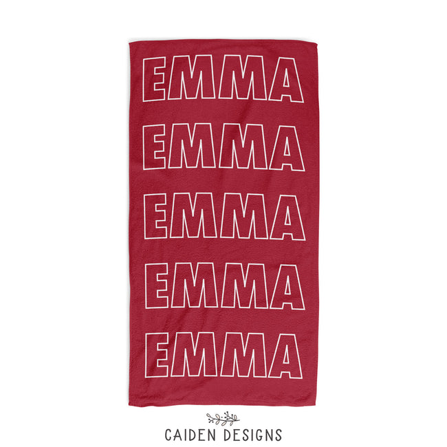 A red personalized beach towel with the name Emma printed on it