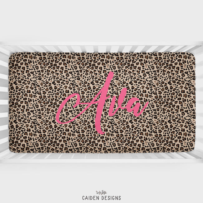 Personalized brown  leopard print crib sheet with name Ava in pink on top