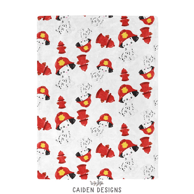A baby blanket with Dalmatian firehouse theme, including images of Dalmatians, fire hydrants, and fire engines.