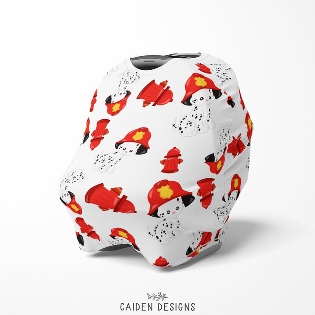 A multicolored baby car seat cover featuring a pattern of dalmatians in firefighter gear on a white background, with a tapered shape and a 1/2" seam.