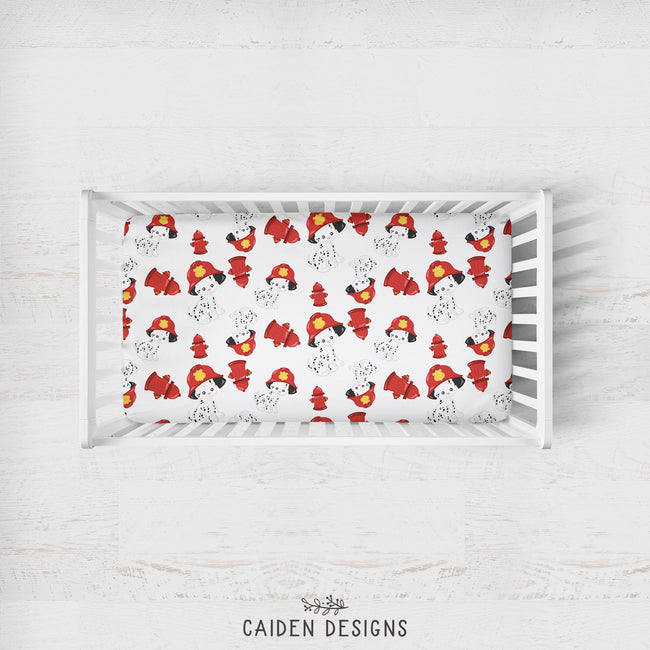 A crib sheet with a pattern of dalmatian dogs in firefighter uniforms. The design is mainly in red and white, with a white crib background.
