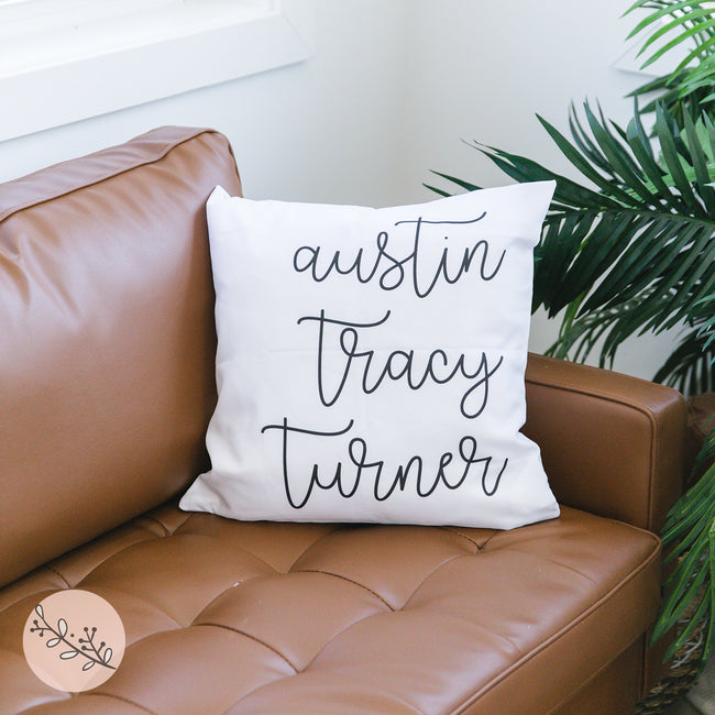 A personalized throw pillow with family names printed on it