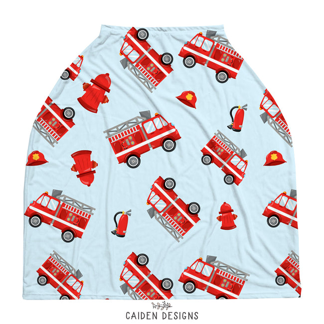 A baby car seat cover featuring red fire trucks on a light blue background 