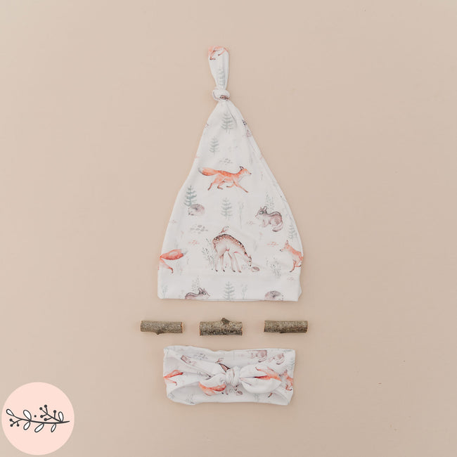 a personalized baby hat and headband featuring a woodland animals design
