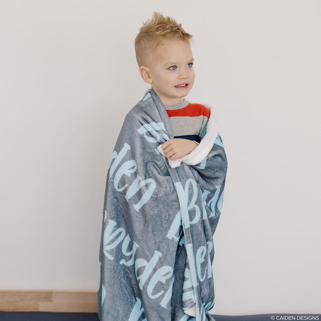 A boy with a personalized name blanket