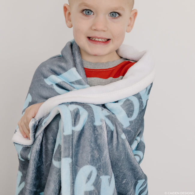 A boy with a personalized name blanket