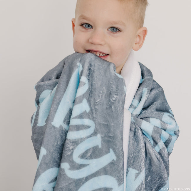 A boy with a personalized name blanket