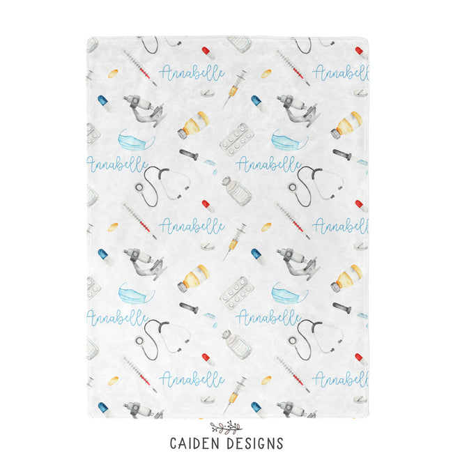 A baby with a medical themed personalized baby blanket
