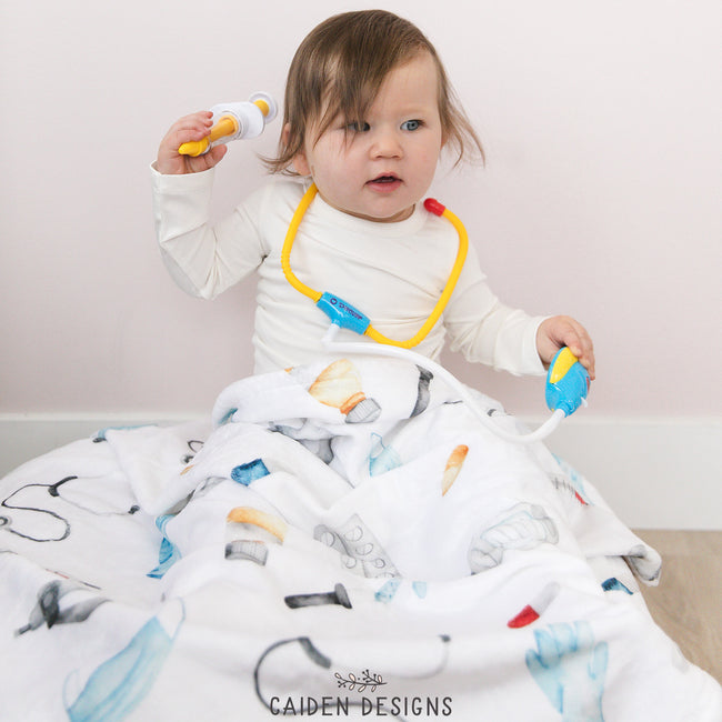 A baby with a medical themed personalized baby blanket