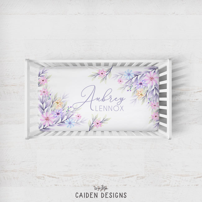 Personalized crib sheet featuring pastel watercolor flowers and names Aubrey Lennox on it