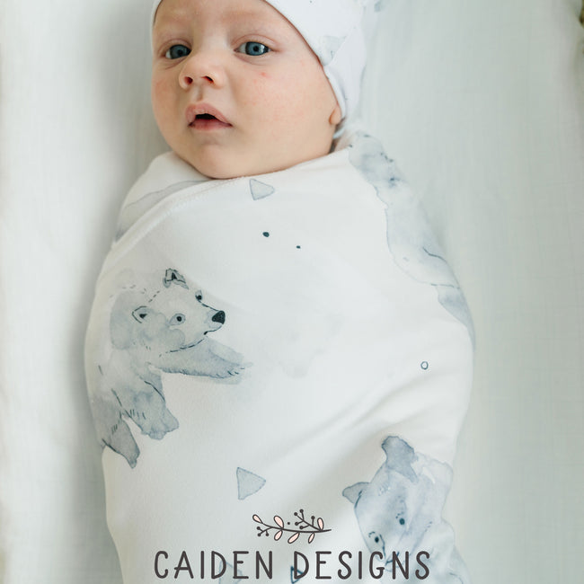 sweet baby wrapped in a monochrome polar bear pattern swaddle blanket and hat set