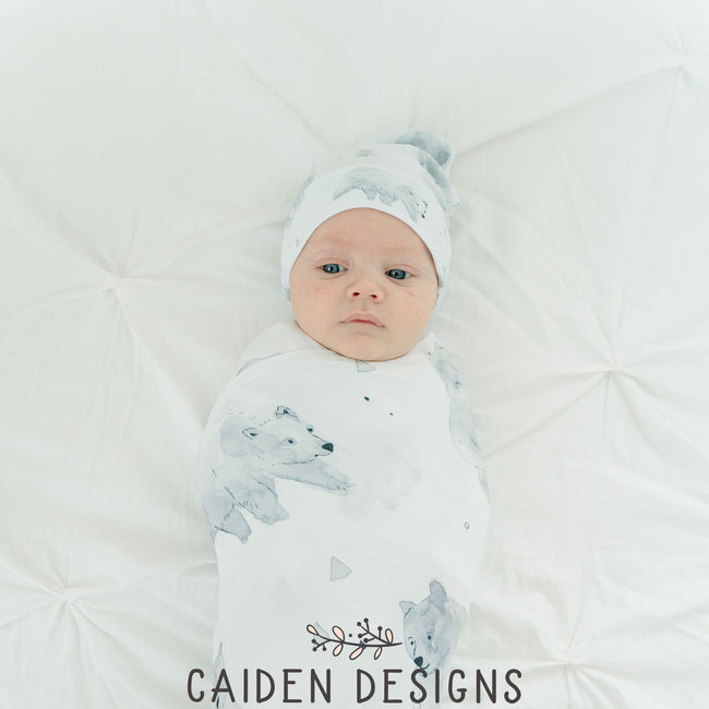 sweet baby wrapped in a monochrome polar bear pattern swaddle blanket and hat set