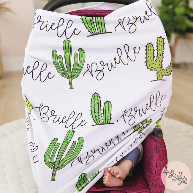 A multi-use personalized baby car seat cover featuring a tropical cactus design and the name Brielle on it