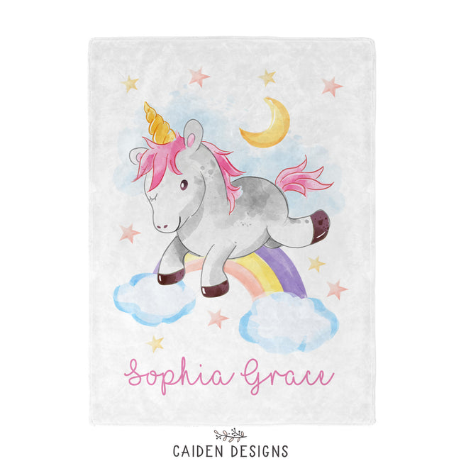 A personalized unicorn blanket with the name 'Sophia Grace' printed on it, featuring a colorful unicorn design and other playful elements like stars and a rainbow.