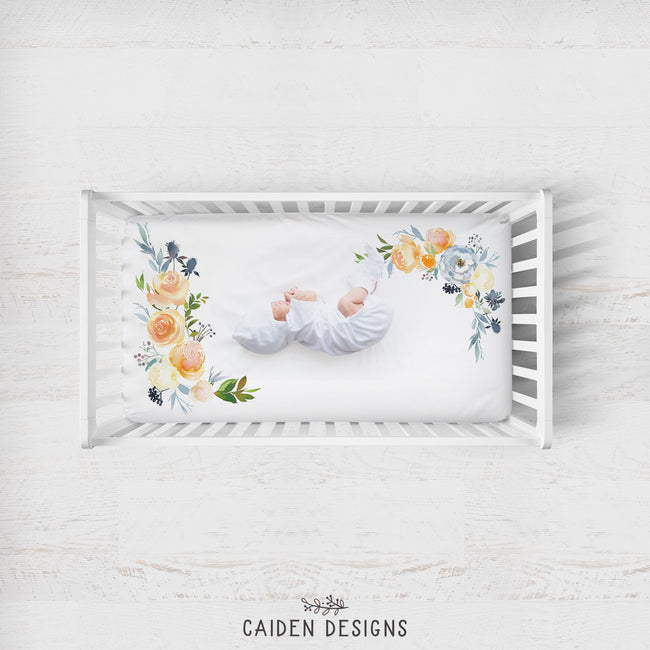 A baby laying on a crib sheet with a floral pattern 